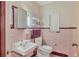Pink tiled bathroom with a vintage sink and toilet at 2425 Riverview Blvd, Bradenton, FL 34205