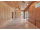 Bright bonus room, wood paneled walls and ceiling, with access to other rooms at 2425 Riverview Blvd, Bradenton, FL 34205