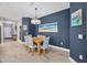 Bright dining room with wooden table and blue accent wall at 2616 Sapphire Blue Ln, Bradenton, FL 34211
