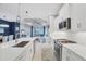 Open kitchen with white cabinets, stainless steel appliances, and quartz counters at 2616 Sapphire Blue Ln, Bradenton, FL 34211