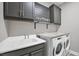 Laundry room with Whirlpool washer and dryer, and lots of storage at 2616 Sapphire Blue Ln, Bradenton, FL 34211