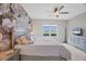 Main bedroom with floral accent wall and large window at 2616 Sapphire Blue Ln, Bradenton, FL 34211