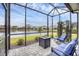 Relaxing screened patio with lake views and comfortable seating at 2616 Sapphire Blue Ln, Bradenton, FL 34211