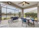 Spacious screened patio with seating area, dining table, and fire pit at 2616 Sapphire Blue Ln, Bradenton, FL 34211