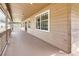 Long front porch with wooden railing and columns at 27019 Golden Meadow Dr, Wesley Chapel, FL 33544