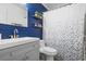 Bathroom with gray vanity and blue shiplap walls at 2744 Hidden Lake Blvd # A, Sarasota, FL 34237