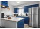 Modern kitchen with blue cabinets and stainless steel appliances at 2744 Hidden Lake Blvd # A, Sarasota, FL 34237