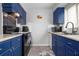 Updated kitchen featuring blue cabinets and modern appliances at 2744 Hidden Lake Blvd # A, Sarasota, FL 34237