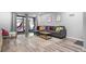 Living area with gray sectional sofa and access to patio at 2744 Hidden Lake Blvd # A, Sarasota, FL 34237