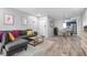 Open living space with gray sectional, dining area, and kitchen at 2744 Hidden Lake Blvd # A, Sarasota, FL 34237