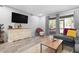 Spacious living room with L-shaped sectional sofa and sliding doors to patio at 2744 Hidden Lake Blvd # A, Sarasota, FL 34237