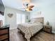 Bedroom with wooden bed frame, ceiling fan, and window at 306 111Th E St, Bradenton, FL 34212