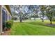 Landscaped backyard with lush lawn and mature trees at 3484 Hadfield Greene # 22, Sarasota, FL 34235