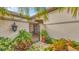 Inviting entryway with an ornate iron gate and lush landscaping at 3484 Hadfield Greene # 22, Sarasota, FL 34235
