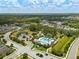 Aerial view of community with pool, lake, and homes at 3543 Woodmont Dr, Parrish, FL 34219