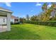 Large backyard with lush grass and privacy hedge at 3543 Woodmont Dr, Parrish, FL 34219