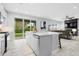 Open concept kitchen with island and sliding glass doors to backyard at 3543 Woodmont Dr, Parrish, FL 34219
