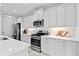 Bright kitchen featuring white cabinets and stainless steel appliances at 3543 Woodmont Dr, Parrish, FL 34219