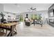 Open concept living space with a gray sectional sofa and farmhouse dining table at 3543 Woodmont Dr, Parrish, FL 34219