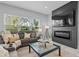 Living area featuring a gray sectional sofa and fireplace at 3543 Woodmont Dr, Parrish, FL 34219