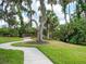 A winding path leads to a charming footbridge nestled within lush greenery at 3543 Woodmont Dr, Parrish, FL 34219