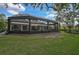 Enclosed pool area with covered patio and lush green lawn at 370 Sugar Mill Dr, Osprey, FL 34229