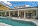 Inviting pool area with covered patio, outdoor kitchen, and ample seating at 370 Sugar Mill Dr, Osprey, FL 34229