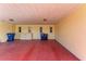 Covered carport with storage cabinets and trash cans at 390 301 W Blvd # 8C, Bradenton, FL 34205