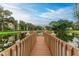 Wooden dock extending over peaceful pond at 390 301 W Blvd # 8C, Bradenton, FL 34205