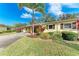 Side view of a single-story home with lush landscaping at 390 301 W Blvd # 8C, Bradenton, FL 34205