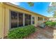 Condo exterior showcasing screened patio and landscaping at 390 301 W Blvd # 8C, Bradenton, FL 34205