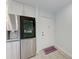 Modern kitchen with stainless steel refrigerator and entry door at 390 301 W Blvd # 8C, Bradenton, FL 34205