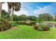 Scenic pond view with lush landscaping and gazebo at 390 301 W Blvd # 8C, Bradenton, FL 34205