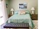 Main bedroom with teal bedding and bench at 3907 10Th Avenue W Dr, Bradenton, FL 34205