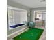 Bedroom with window seat, putting green, and second bedroom view at 3907 10Th Avenue W Dr, Bradenton, FL 34205