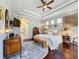 Bright bedroom with hardwood floors, a king-size bed and ensuite bathroom at 4679 Tuscana Dr, Sarasota, FL 34241