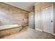 Bathroom with a large bathtub and a glass-block shower at 4841 Edgemont Ct, Sarasota, FL 34233