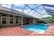 Inviting pool area with brick deck, screened enclosure, and spa at 4841 Edgemont Ct, Sarasota, FL 34233