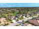 An aerial view of Rosedale community homes and surrounding wooded areas under a bright blue, partly cloudy sky at 5245 88Th E St, Bradenton, FL 34211