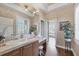Bright bathroom vanity with a large mirror, garden view, and tile countertop at 5245 88Th E St, Bradenton, FL 34211