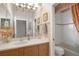Bathroom featuring wood vanity, sink, chandelier lighting, and view into adjacent toilet and shower room at 5245 88Th E St, Bradenton, FL 34211
