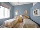 Bedroom with twin beds, neutral decor, blue accent walls, and ceiling fan at 5245 88Th E St, Bradenton, FL 34211