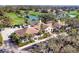Beautiful clubhouse with a well-manicured landscape, palm trees, and ample parking space for visitors at 5245 88Th E St, Bradenton, FL 34211