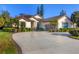 Elegant single-story home boasting a large driveway, tile roof and professionally landscaped yard at 5245 88Th E St, Bradenton, FL 34211