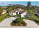 Beautiful single-story home featuring a tile roof, circular driveway, and lush landscaping at 5245 88Th E St, Bradenton, FL 34211