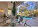 Covered outdoor dining area overlooking pool and verdant landscaping at 5245 88Th E St, Bradenton, FL 34211