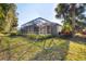 The backyard featuring a screened lanai surrounded by lush landscaping and a beautiful green lawn at 5245 88Th E St, Bradenton, FL 34211