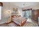 Cozy bedroom featuring a ceiling fan, light-colored walls, and hardwood flooring at 5245 88Th E St, Bradenton, FL 34211