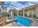 Screened in pool with hot tub, tropical landscaping and an outdoor living space beyond at 5245 88Th E St, Bradenton, FL 34211