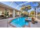 Screened in pool with hot tub and tropical landscaping and an outdoor living space beyond at 5245 88Th E St, Bradenton, FL 34211